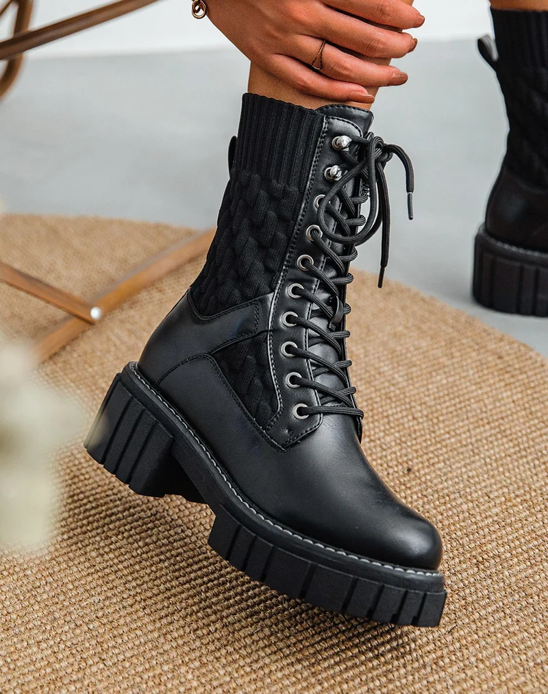 Bottines montantes noires bi-matière à semelle talonnée et crantée