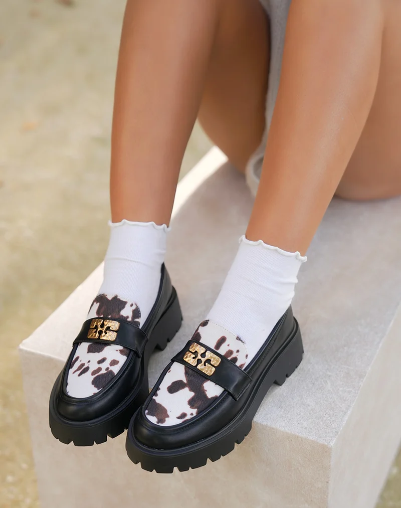 Mocassins noirs bi-matière imprimé vachette avec bijou doré